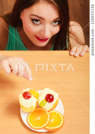 Woman eating delicious sweet cake. Gluttony. 126033138