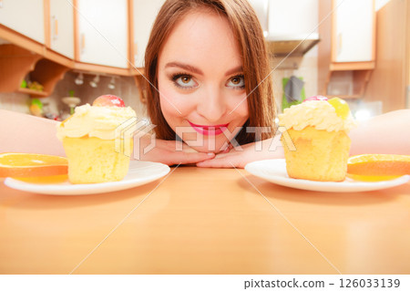 Woman looking at delicious sweet cake. Gluttony. 126033139