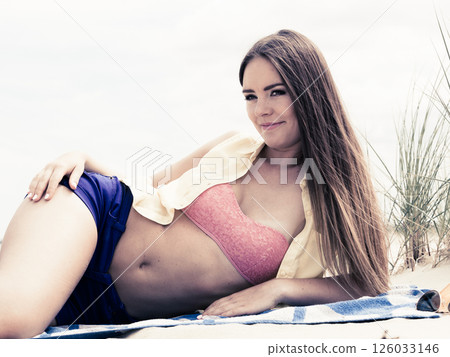 Woman resting on beach. Woman resting on beach. 126033146