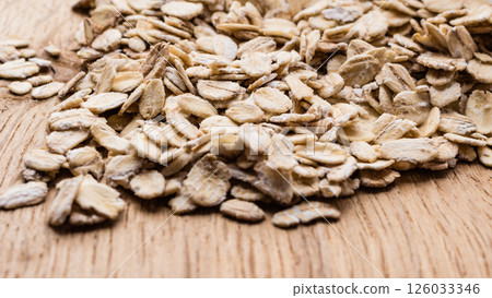 oat flakes cereal on wooden table. 126033346