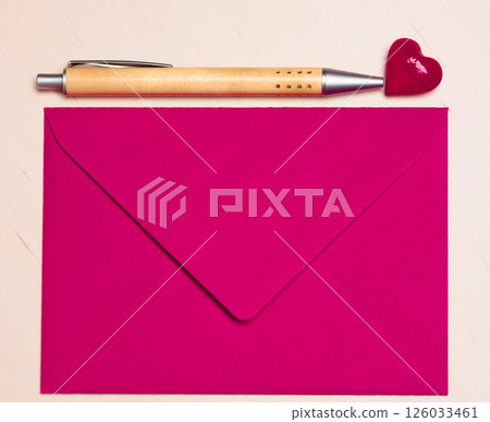Pink envelope heart and pen on table Pink envelope heart and pen on table 126033461