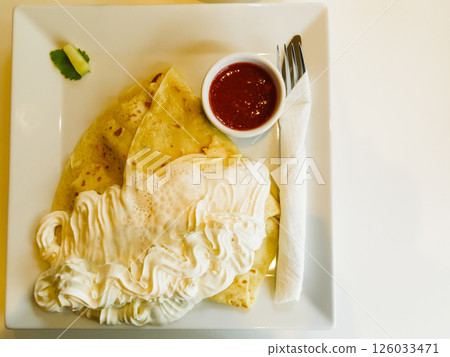 Pancake with wipped cream and strawberry sauce 126033471