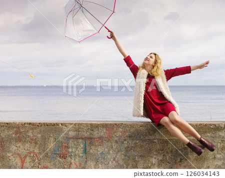 Happy woman holding umbrella 126034143