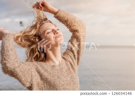 Happy woman outdoor wearing jumper 126034146