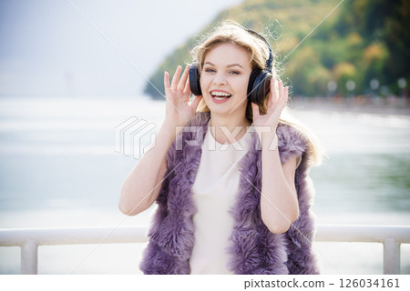 Happy woman wearing headphones outdoor Happy woman wearing headphones outdoor 126034161
