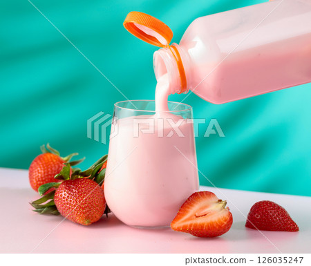 Strawberry milkshake smoothie and fresh berries on a colorful background. 126035247