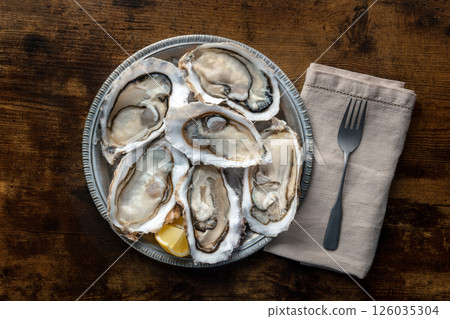 Fresh raw oysters on ice, overhead flat lay shot 126035304