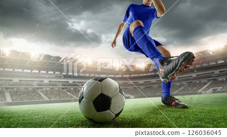 Cropped image of man, soccer player in blue uniform powerfully kicks ball during intense match in stormy weather. 3D stadium. 126036045