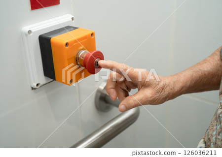 Asian elderly woman press emergency button in toilet. Asian elderly woman press emergency button in toilet. 126036211