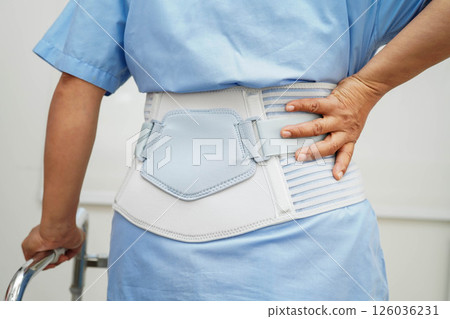 Asian woman wearing lumbar support pain back and use walker in hospital. Asian woman wearing lumbar support pain back and use walker in hospital. 126036231