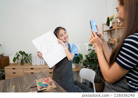 Family time capturing artistic moments with a phone 126036240