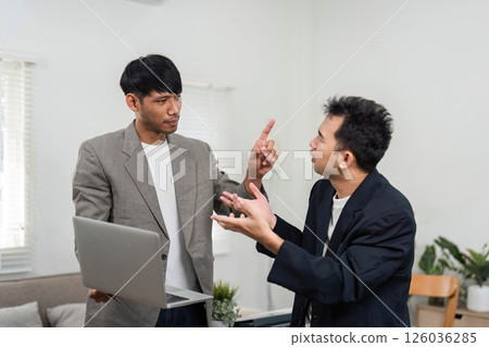 Business Engagement and Strategy Discussion. Two professionals animatedly discussing project outcomes in a contemporary workspace. Business Engagement and Strategy Discussion. Two professionals animatedly discussing project outcomes in a contemporary workspace. 126036285