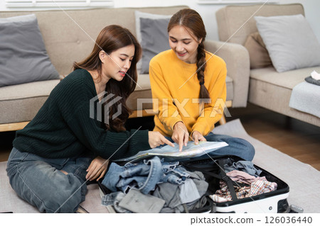 Planning and Packing: Friends reviewing outfits for their trip 126036440