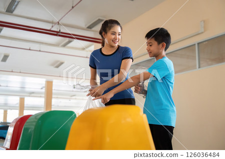 Engaging Youth and Sustainability. Children and adults participate in waste management efforts, fostering eco-friendly practices. Engaging Youth and Sustainability. Children and adults participate in waste management efforts, fostering eco-friendly practices. 126036484