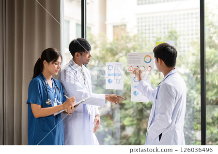 Healthcare teamwork: Medical staff evaluating performance metrics Healthcare teamwork: Medical staff evaluating performance metrics 126036496