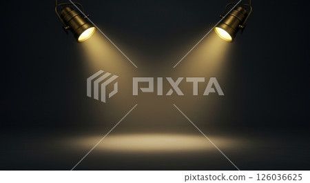 Two antique brass spotlights hang from the top, casting warm yellow light on a smooth dark grey studio wall and floor for product placement. 126036625