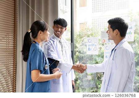 Doctor shaking hands with colleagues in a healthcare meeting Doctor shaking hands with colleagues in a healthcare meeting 126036768
