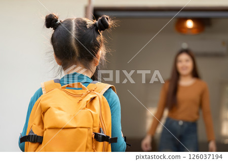 Love and Support for School Adventures. A girl turns to her mother as they prepare for a new day together. 126037194