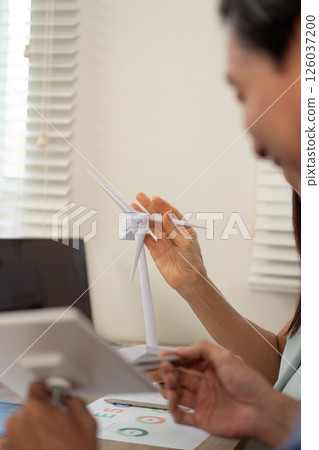 Sustainability ESG discussion with professionals around wind turbines 126037200