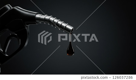 Fuel nozzle with a single drop of viscous dark liquid. Heavy duty black dispenser with a thick droplet. Automotive and industrial concept. 126037286
