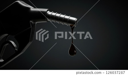 Fuel dispenser nozzle with a thick dark droplet of viscous liquid hanging. Heavy duty black pump on dark background. Automotive and energy concept. 126037287