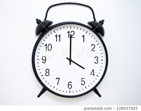 Black Retro Alarm Clock Showing 04:00 or 16:00. Classic Bell Style on White Wood Background. 126037885