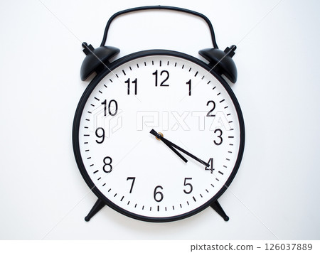 Black Retro Alarm Clock Showing 04:20 or 16:20. Classic Bell Style on White Wood Background. Black Retro Alarm Clock Showing 04:20 or 16:20. Classic Bell Style on White Wood Background. 126037889