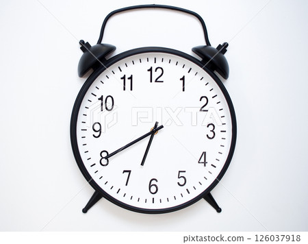 Black Retro Alarm Clock Showing 06:40 or 18:40. Classic Bell Style on White Wood Background. 126037918
