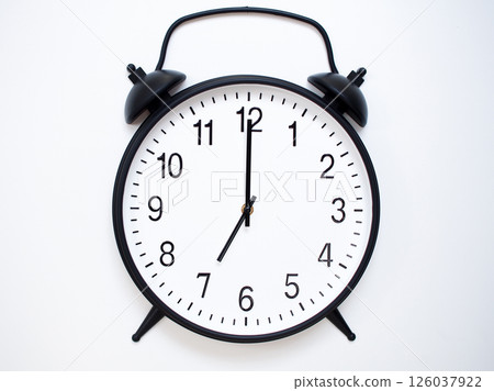 Black Retro Alarm Clock Showing 07:00 or 19:00. Classic Bell Style on White Wood Background. 126037922