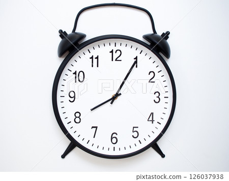 Black Retro Alarm Clock Showing 08:05 or 20:05. Classic Bell Style on White Wood Background. Black Retro Alarm Clock Showing 08:05 or 20:05. Classic Bell Style on White Wood Background. 126037938