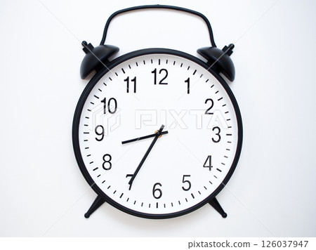 Black Retro Alarm Clock Showing 08:35 or 20:35. Classic Bell Style on White Wood Background. 126037947