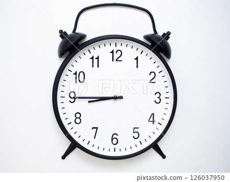 Black Retro Alarm Clock Showing 08:45 or 20:45. Classic Bell Style on White Wood Background. Black Retro Alarm Clock Showing 08:45 or 20:45. Classic Bell Style on White Wood Background. 126037950