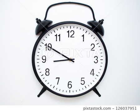 Black Retro Alarm Clock Showing 08:50 or 20:50. Classic Bell Style on White Wood Background. Black Retro Alarm Clock Showing 08:50 or 20:50. Classic Bell Style on White Wood Background. 126037951
