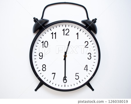 Black Retro Alarm Clock Showing 00:30 or 12:30. Classic Bell Style on White Wood Background. 126038019