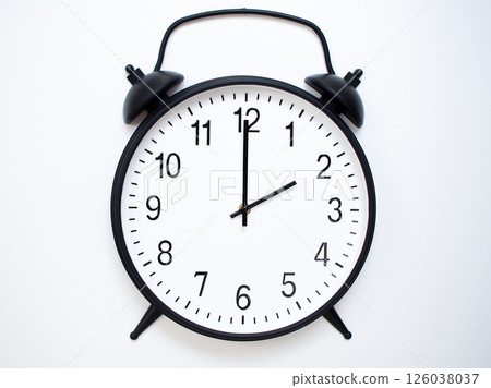 Black Retro Alarm Clock Showing 02:00 or 14:00. Classic Bell Style on White Wood Background. Black Retro Alarm Clock Showing 02:00 or 14:00. Classic Bell Style on White Wood Background. 126038037