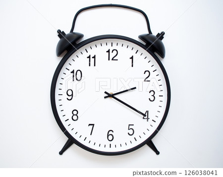 Black Retro Alarm Clock Showing 02:20 or 14:20. Classic Bell Style on White Wood Background. 126038041