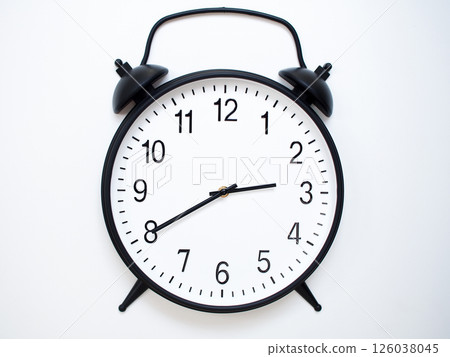 Black Retro Alarm Clock Showing 02:40 or 14:40. Classic Bell Style on White Wood Background. 126038045
