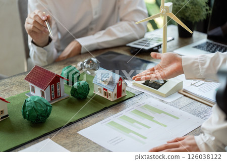 Renewable Solutions and Eco-Architecture. A team presenting a model of sustainable homes and renewable energy. 126038122