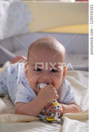 Happy Baby Playing with Toys on a Blanket 126038161