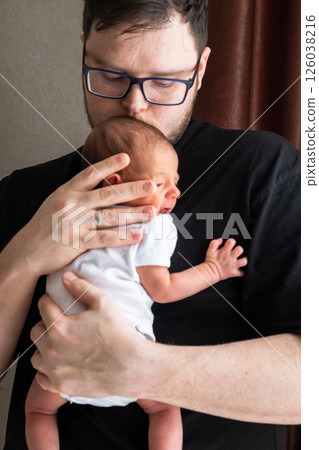 Man Holding Newborn Baby in Tender Moment 126038216
