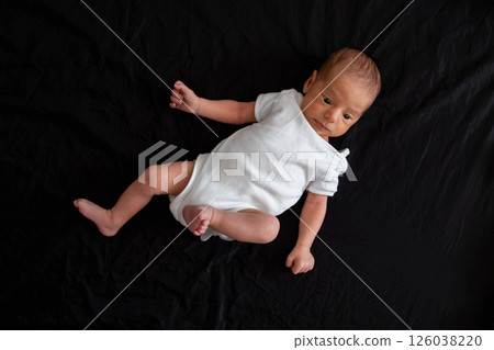Newborn Baby on Black Background 126038220