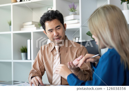Business professionals discussing strategies in a modern office setting 126038356