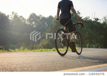 Woman cycling without hold the handlebaron summer tropical park trail 126038376