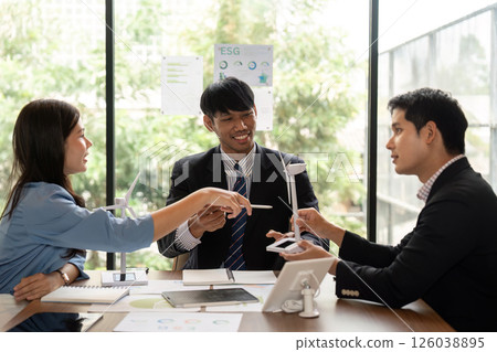 Sustainable ESG meeting with diverse professionals discussing charts Sustainable ESG meeting with diverse professionals discussing charts 126038895