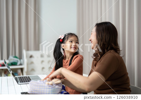 Back to School and Joyful Moments. A mother shares a joyful interaction with her daughter while preparing for school. 126038910