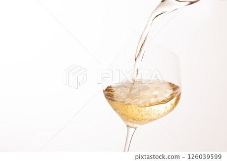 Pour white wine into the glass 126039599