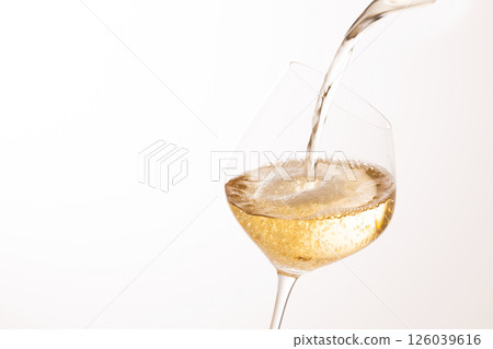 Pour white wine into the glass 126039616