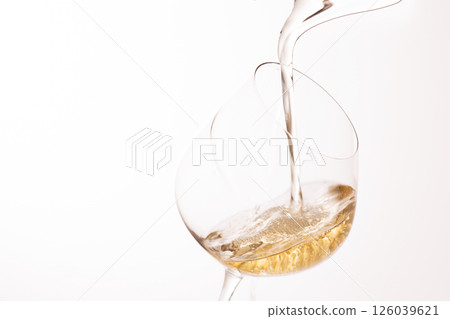 Pour white wine into the glass Pour white wine into the glass 126039621