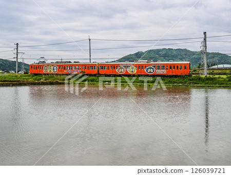 Omi Railway wrapped train reflected in the water of a rice field at Shin-Meishin Tsuchiyama Service Area Omi Railway wrapped train reflected in the water of a rice field at Shin-Meishin Tsuchiyama Service Area 126039721
