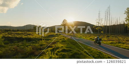 Motorcycle Rider in a Beautiful Sunset Rural Landscape. Action Sports Shot of Touring Motorbike. 126039821
